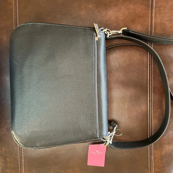 This is a NWT Kate Spade purse in black pebble leather with gold furnishings. - Picture 2 of 9